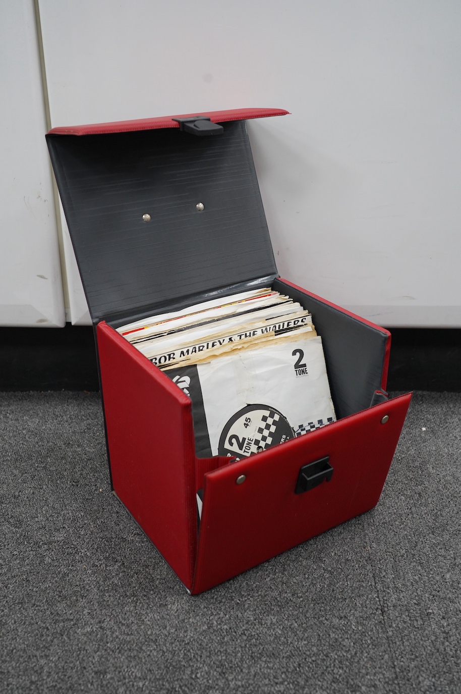 Thirty-six 7” singles, mainly on Two Tone etc. label, artists including; Gangsters, Madness, The Boiler, etc. contained in a singles carry case. Condition - fair